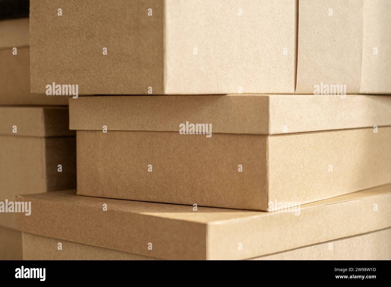 Kraft boxes, stacked paper sealed packages. Stack parcel in warehouse. Product packaging. Stock Photo