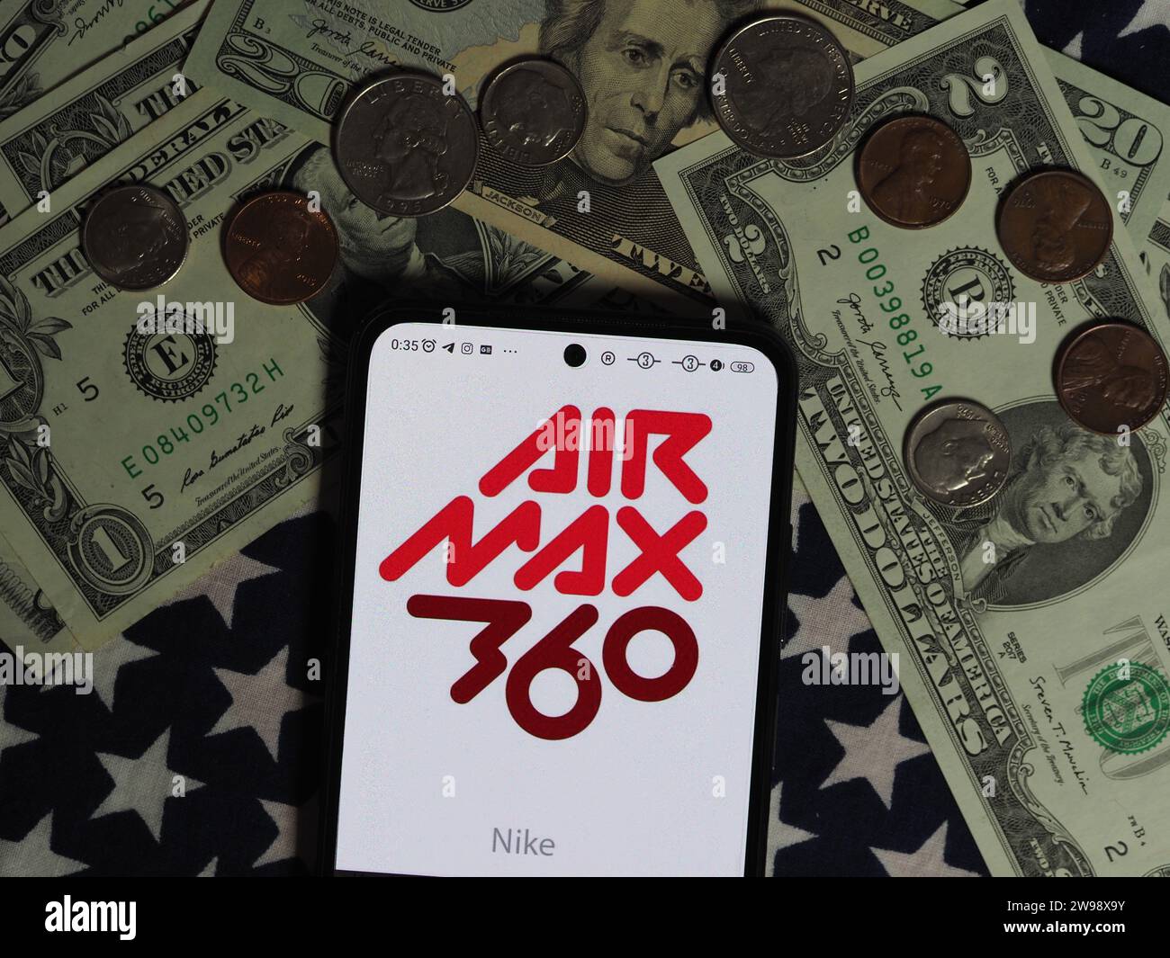 Germany. 25th Dec, 2023. In this photo illustration, a Nike Air Max logo seen displayed on a smartphone with United States Dollar notes and coins in the background. Credit: SOPA Images Limited/Alamy Live News Stock Photo