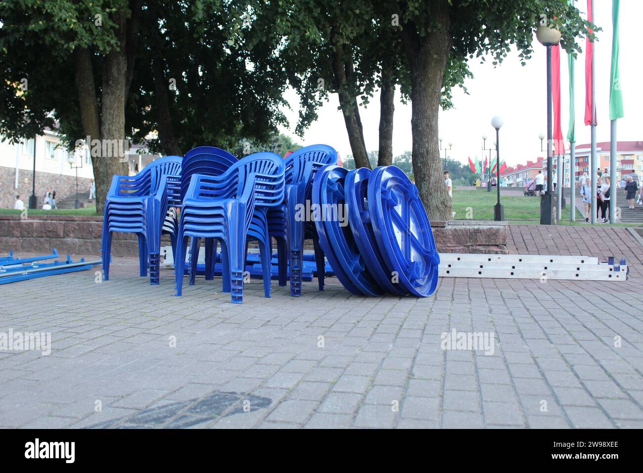 Blue plastic chairs stand in a heap in a group. Recycled plastic furniture. Stock Photo