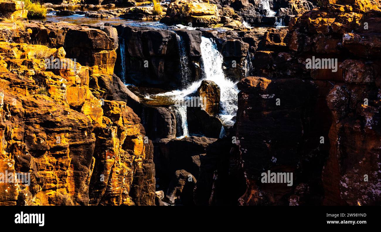 A majestic waterfall cascading down the side of a mountain, surrounded ...