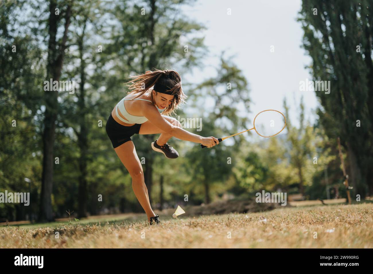 A female badminton player falling after an unsuccessful attempt to ...