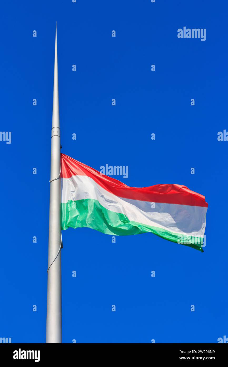 The national flag of Hungary flying proudly outside the Hungarian Parliament building in Budapest, Hungary Stock Photo