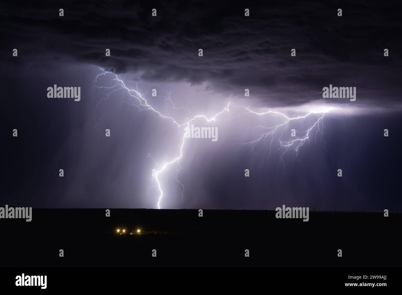 A forked lightning strike from a thunderstorm in Arizona Stock Photo ...