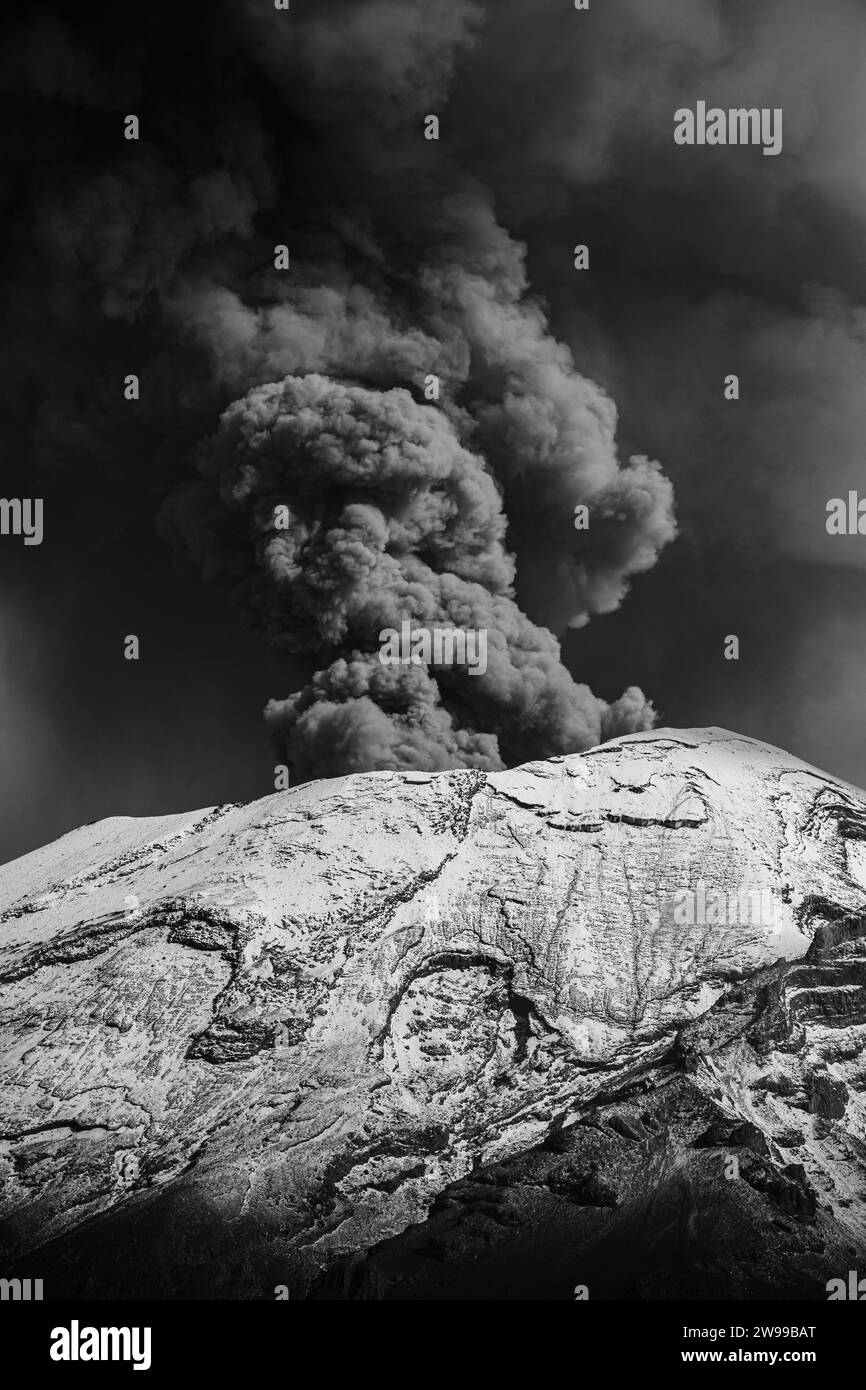 A scenic view of an erupting volcano in grayscale Stock Photo