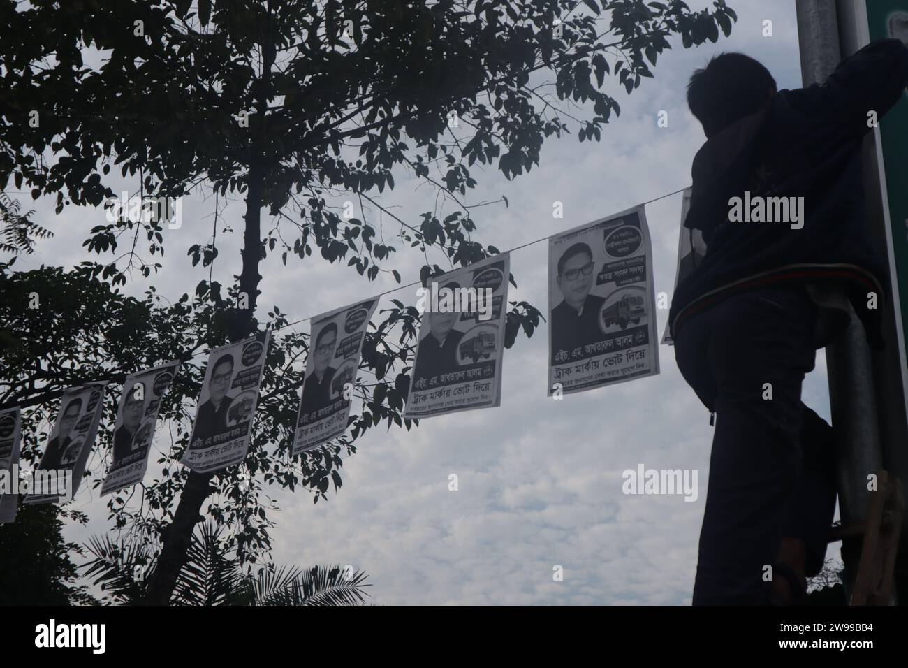 Naogaon Bangladesh 26th Dec 2023 A Boy Hangs Posters Ahead Of The