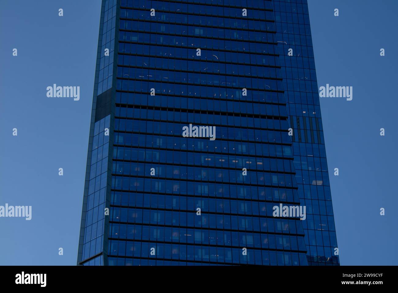 A high-angle shot of the exterior of a tall, modern building with multiple windows on each side Stock Photo