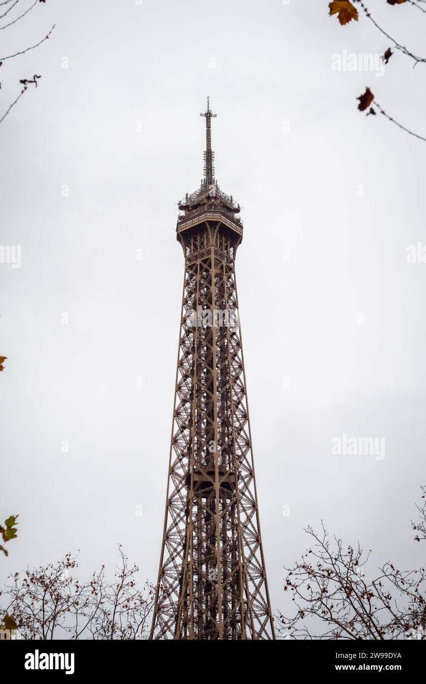 The Eiffel Tower in Paris framed by autumn branches - France Stock Photo