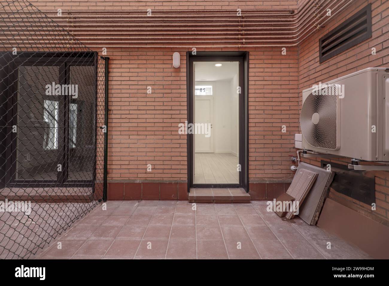 Interior patio of a house with a separating metal fence with access to