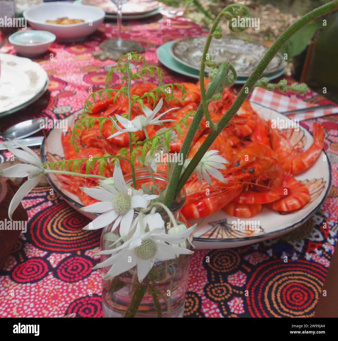 Flannel flowers and bowl of tiger prawns on table, Australian Christmas lunch Stock Photo