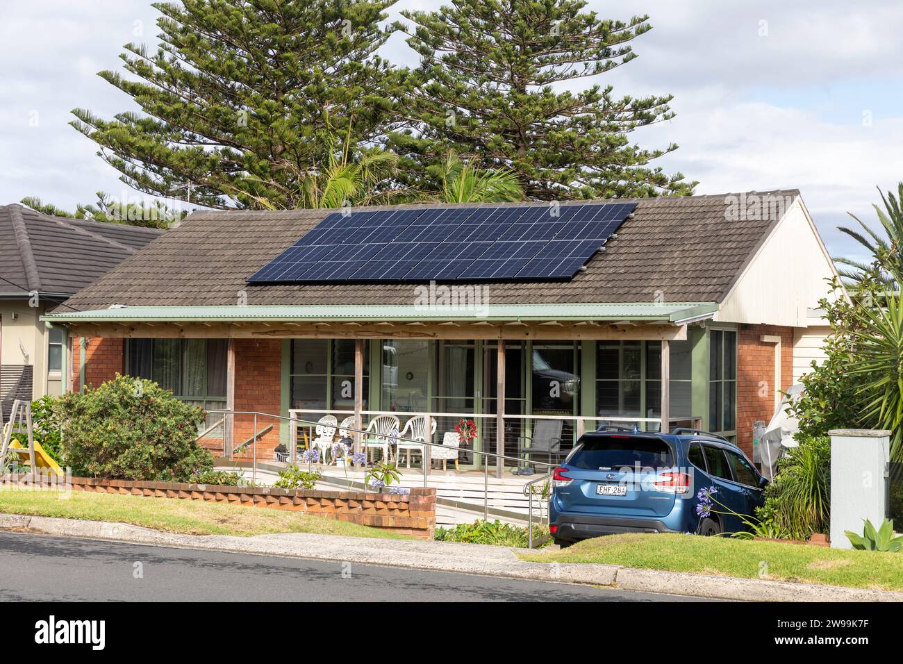 Detached home in Warriewood Sydney Australia, traditional bungalow style home with PV solar panels on the roof providing solar power to the house. Stock Photo