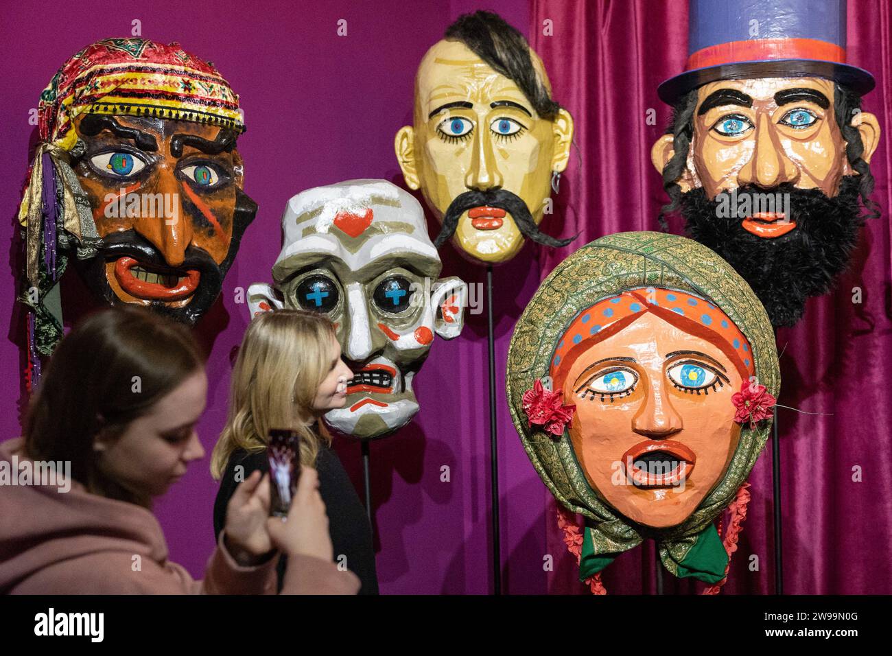 Kyiv, Ukraine. 24th Dec, 2023. A visitor takes photos of giant nativity