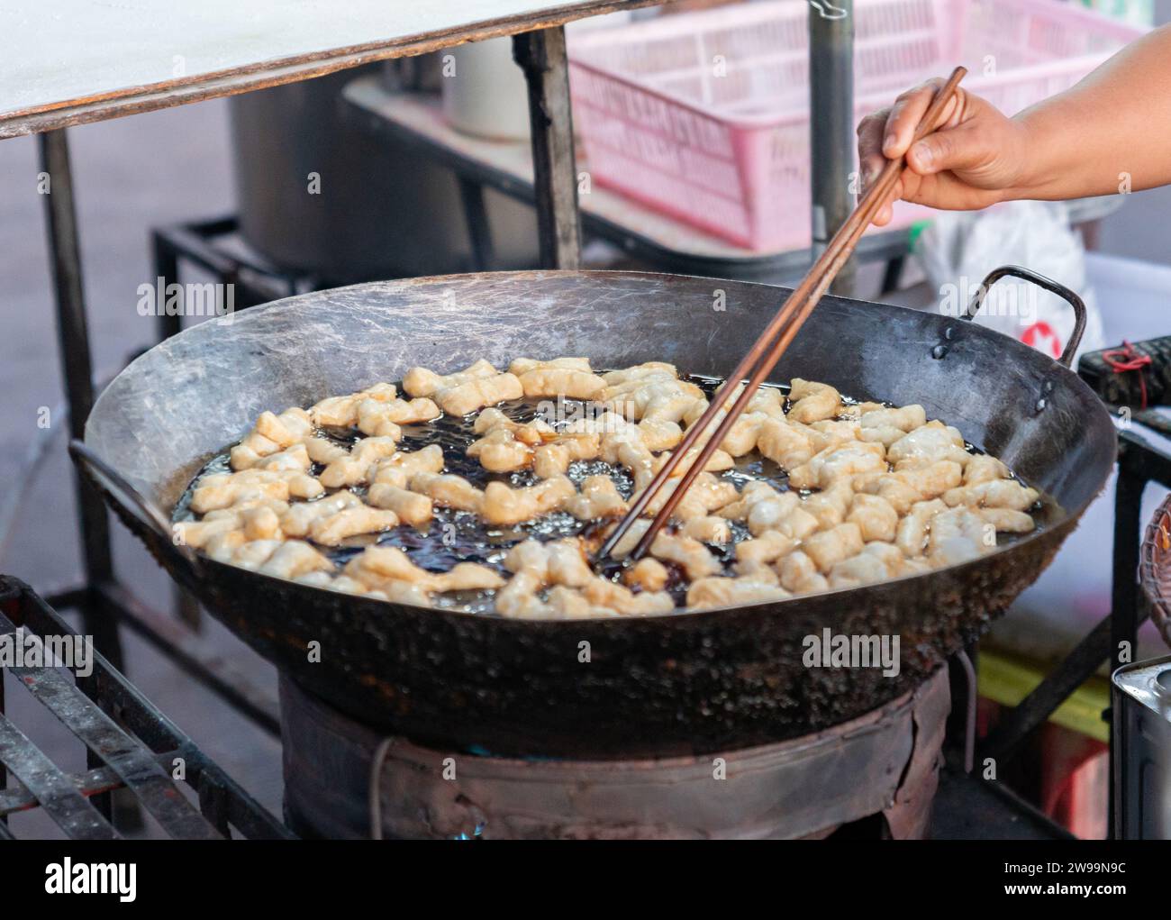 Deep fried doughstick in giant hot oil pan, It is a dilicious and easy fresh breakfast in the Asian countries. Stock Photo