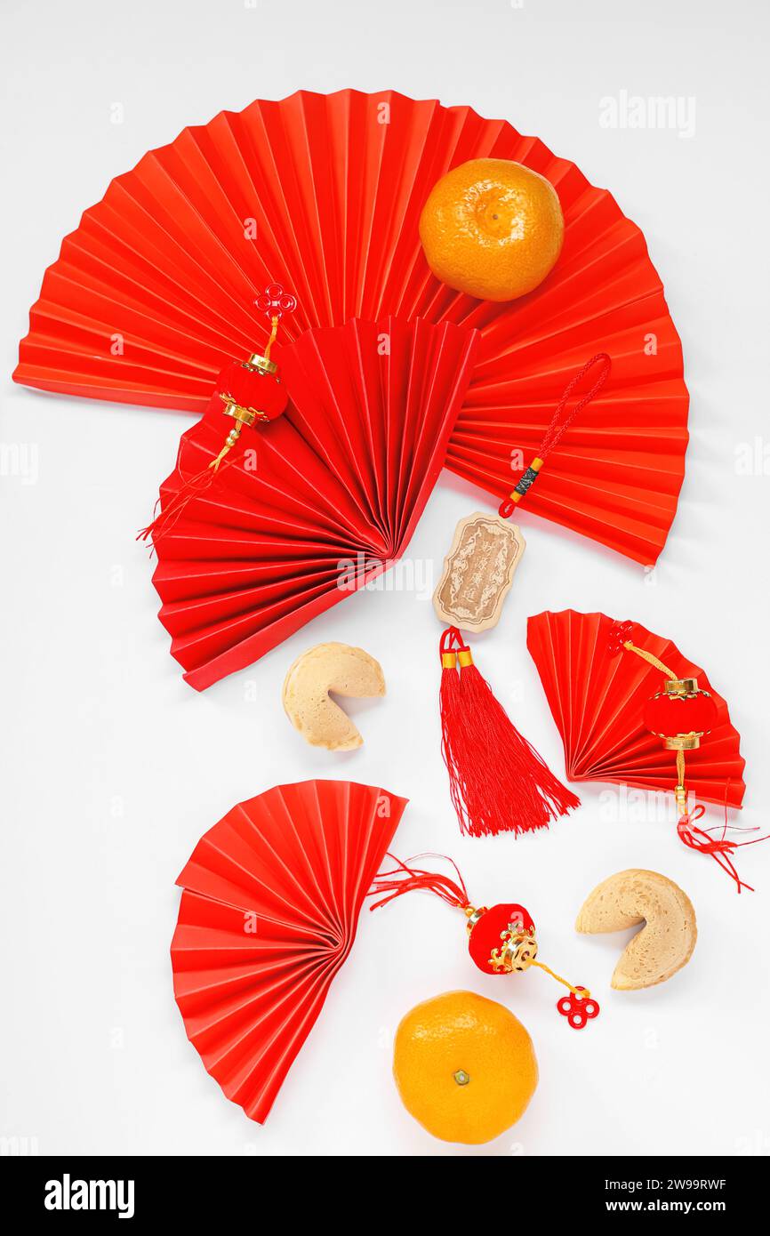 Chinese symbols with tangerines and fortune cookies on white background