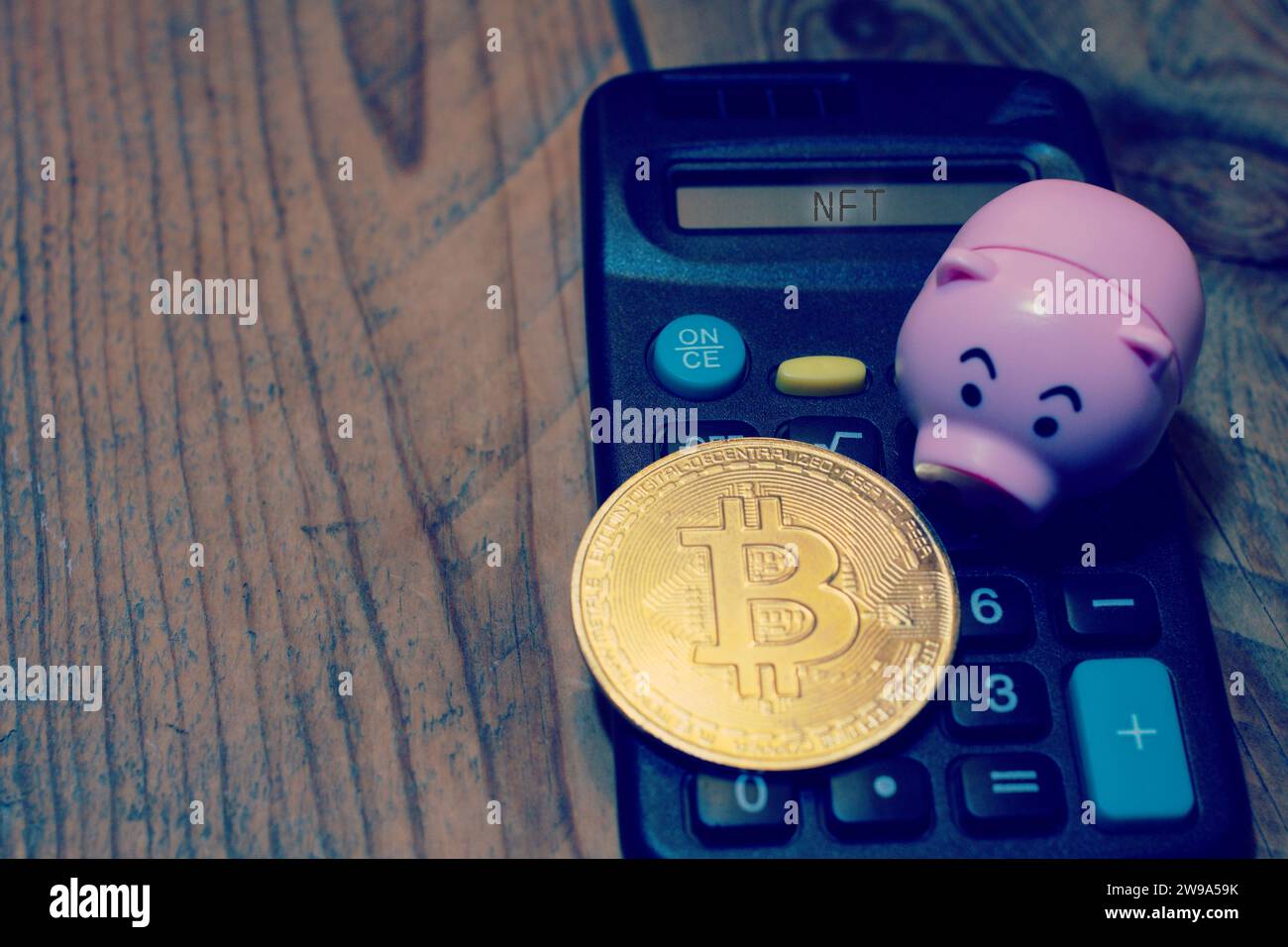 Bitcoin on top of calculator Stock Photo - Alamy