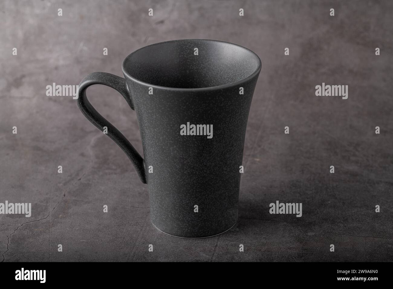 Empty black porcelain cup on gray stone background Stock Photo