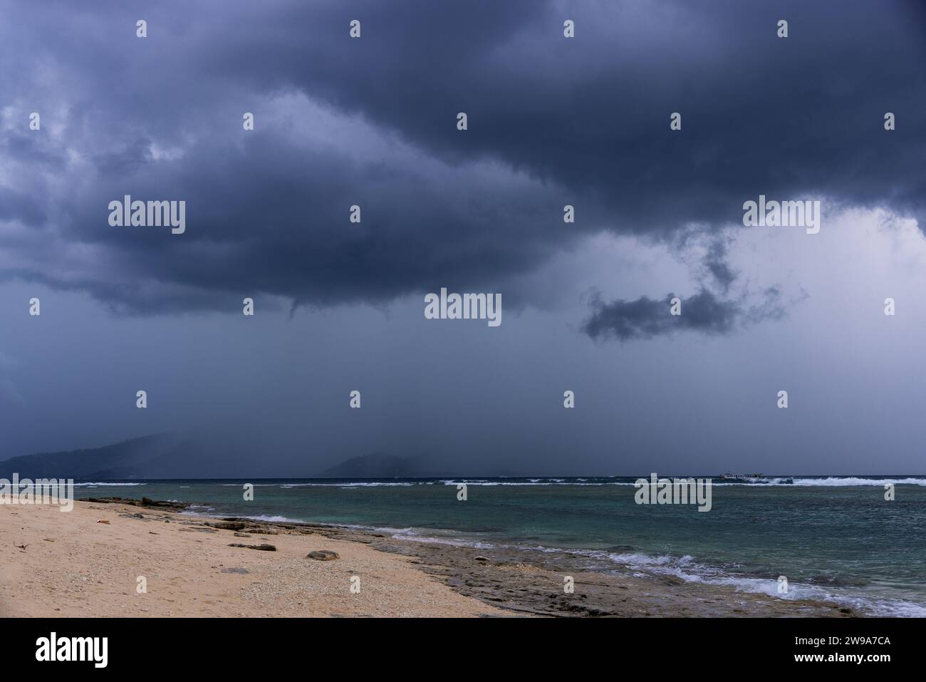 Storm clouds over Lombok Island, seen from Gili Meno Island, Indonesia Stock Photo