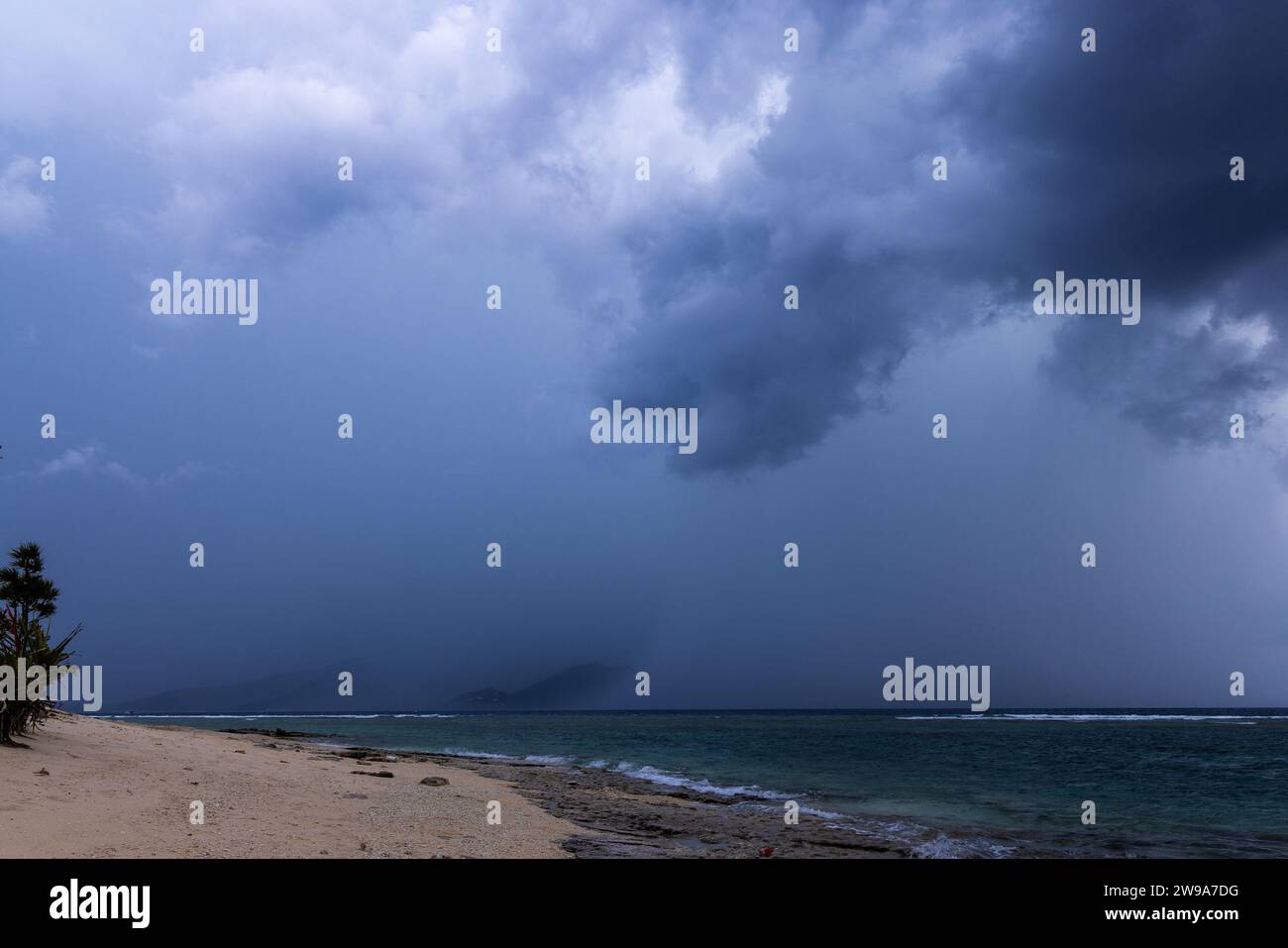 Storm clouds over Lombok Island, seen from Gili Meno Island, Indonesia Stock Photo