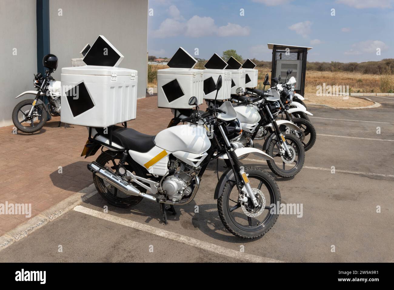 delivery motorbikes, parked in the parking lot waiting for customers Stock Photo