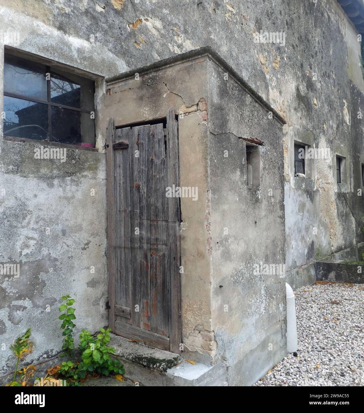detail of the room used as an external toilet with a wooden door that