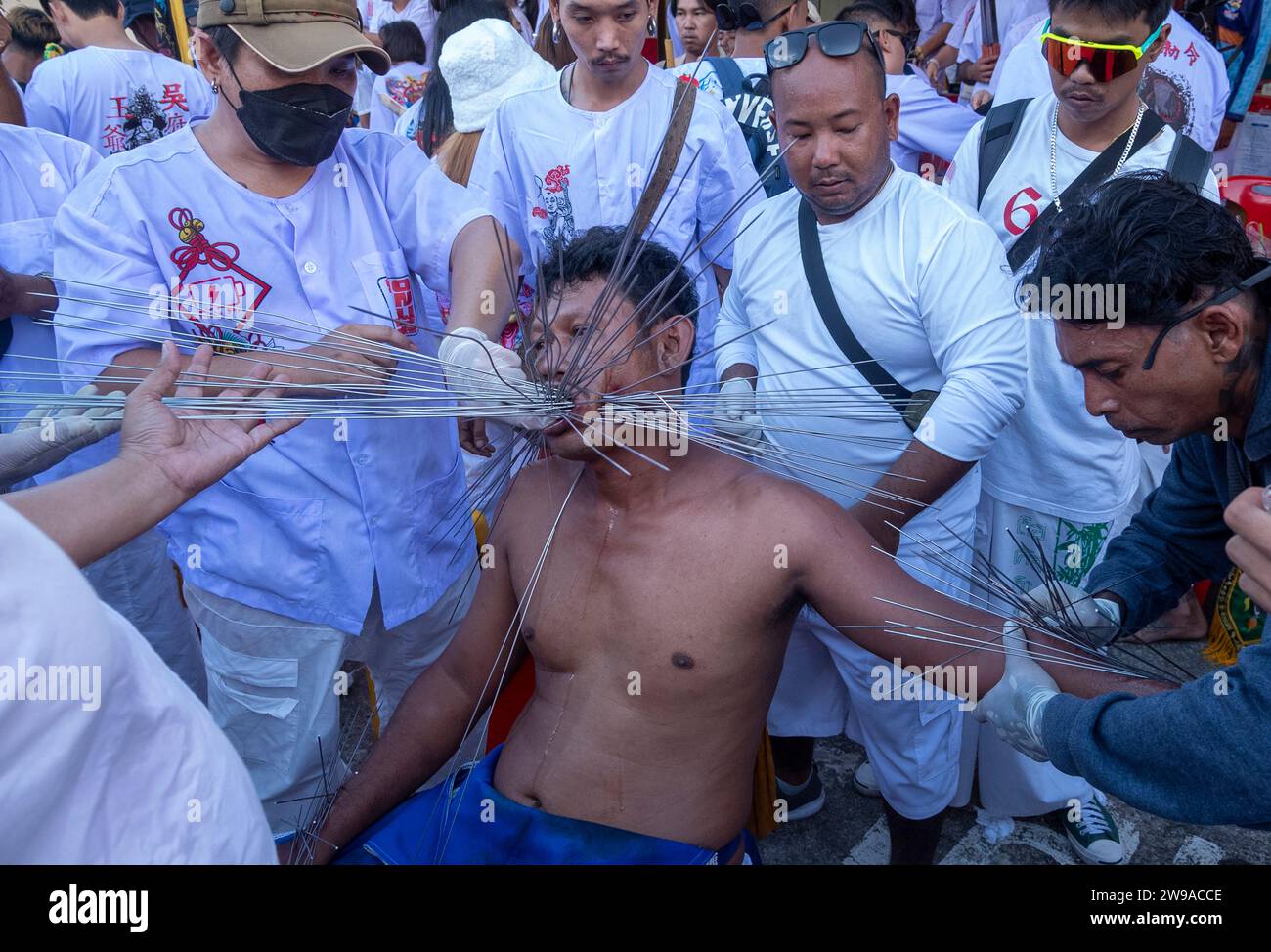 A devotee gets pierced at Bang Neow Shrine during the annual Vegetarian Festival in Phuket Town, Thailand. Thailand's tourism numbers are on track in Stock Photo