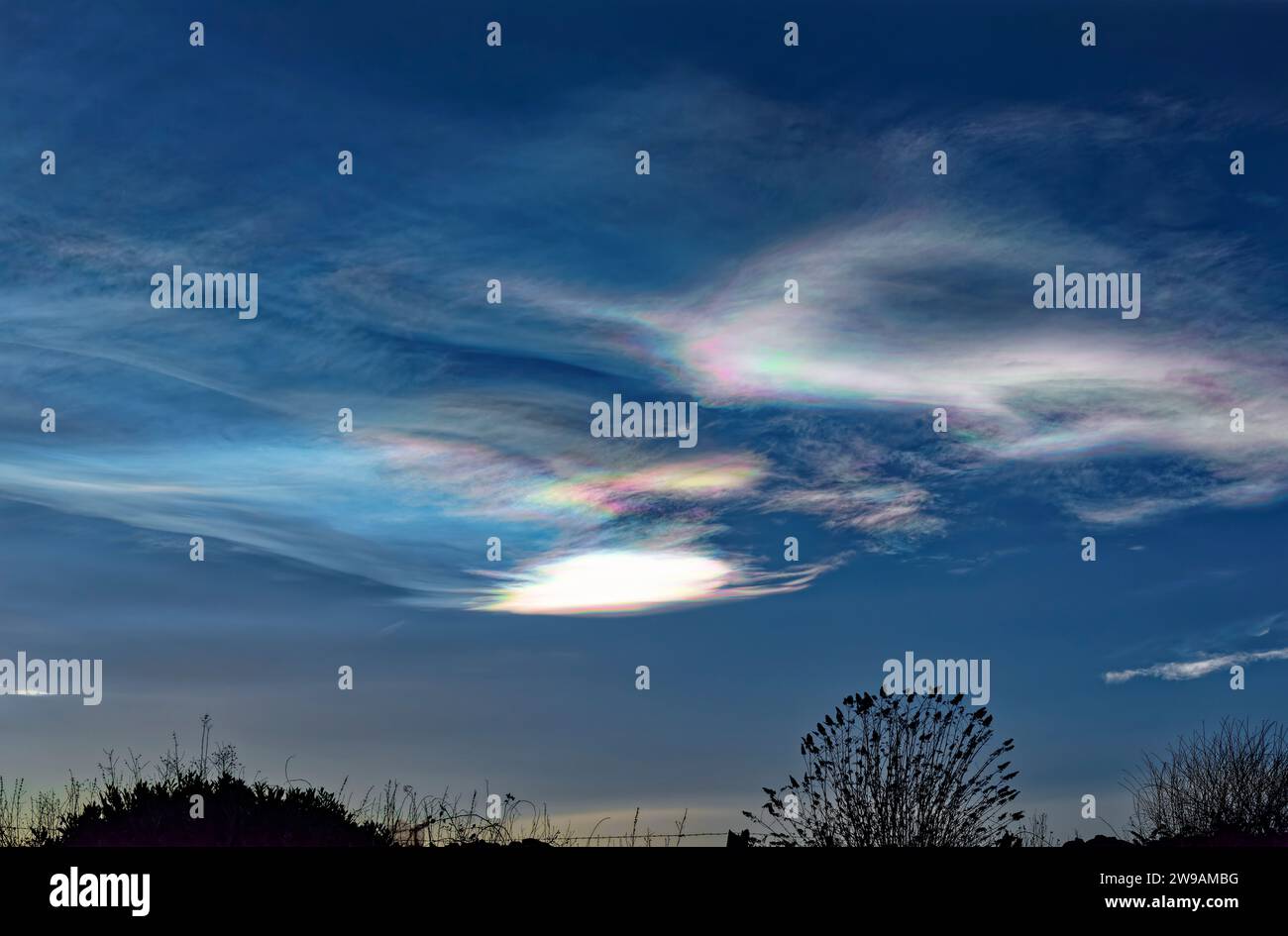 Iridescent Nacreous Clouds forming above Arbroath in the Upper Atmosphere on a cold Christmas Eve. Stock Photo