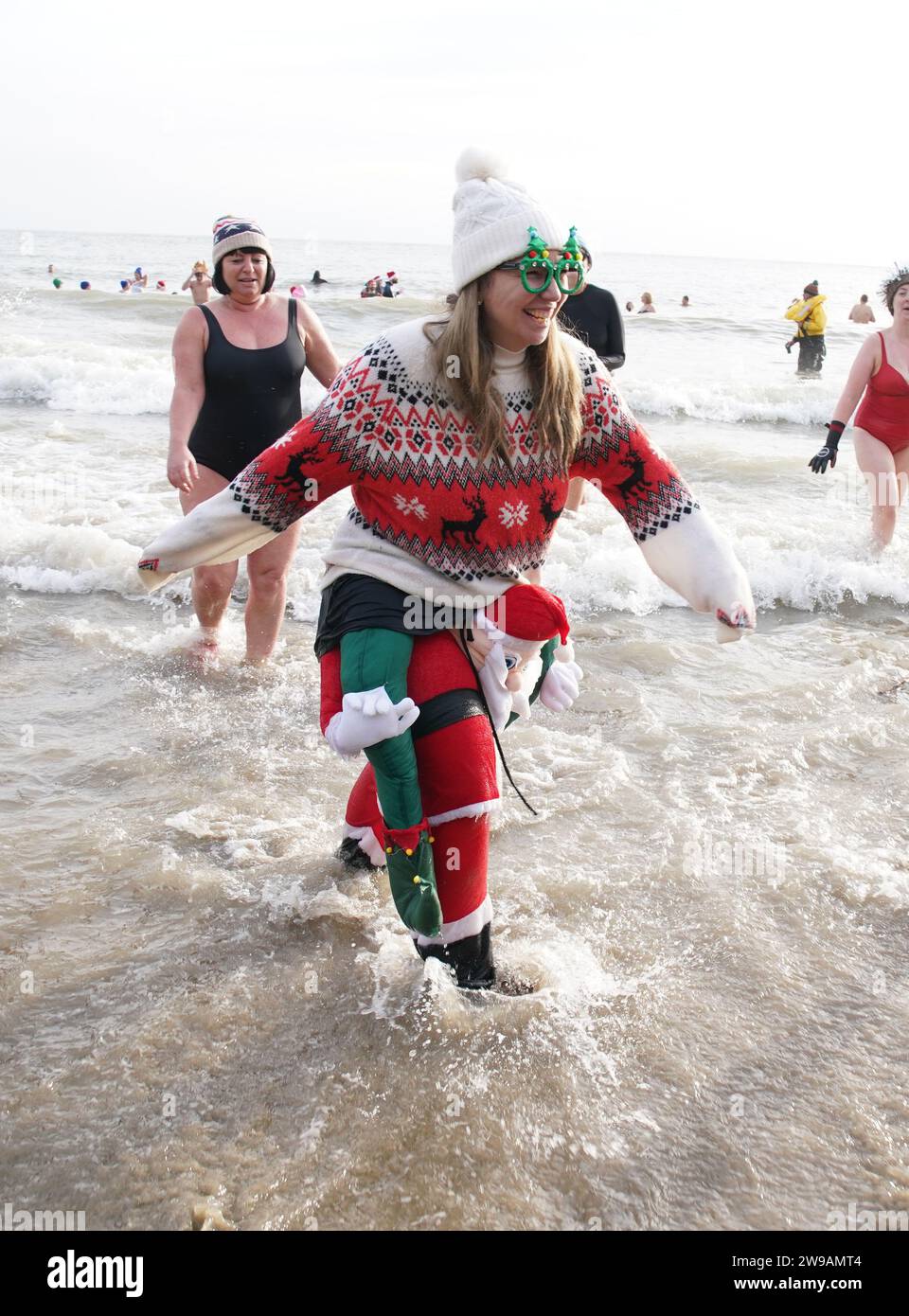 Swimmers take part in the Folkestone Lions' Boxing Day Dip at Sunny Sands Beach in Folkestone, Kent. Picture date: Tuesday December 26, 2023. Stock Photo