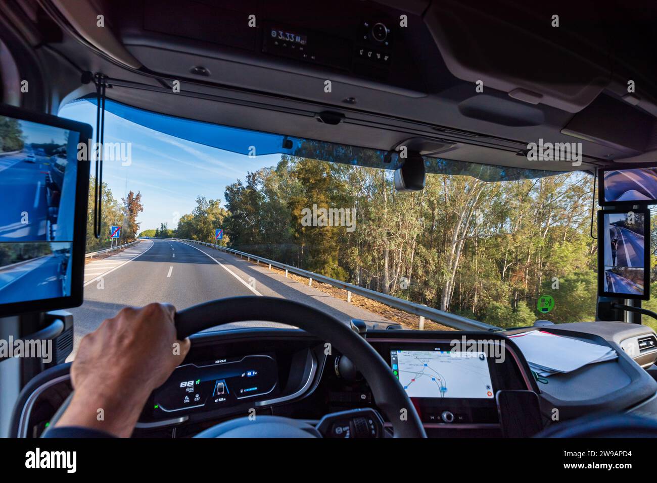 View from the driver's position of a truck on the road of the interior of the cabin with the screens as rearview mirrors. Stock Photo