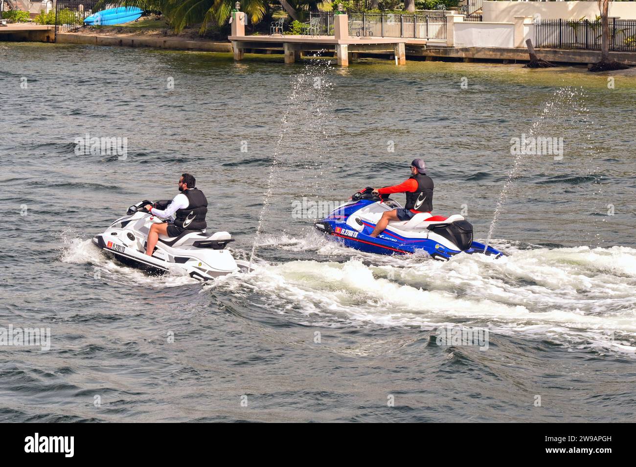Fort Lauderdale, Florida, USA - 2 December 2023: Two people riding jet ...