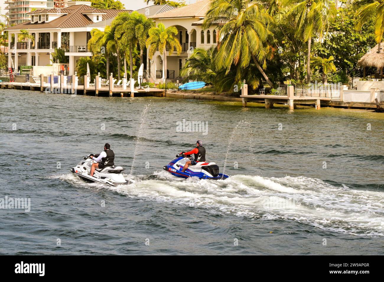 Fort Lauderdale, Florida, USA - 2 December 2023: Two people riding jet ...
