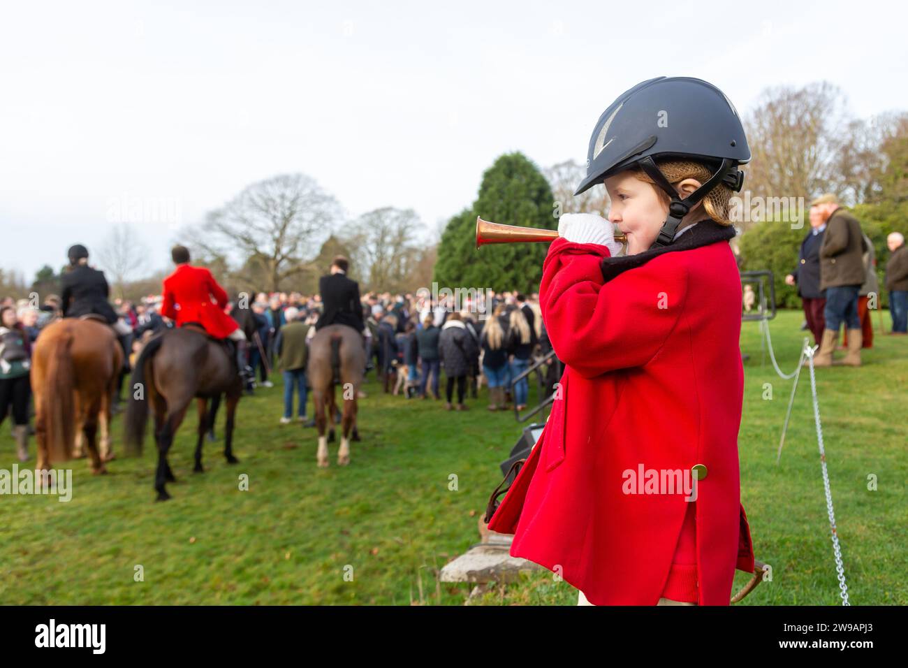 Hagley, Worcestershire, UK. 26th Dec, 2023. 4 year old Myla Mills blows her horn for the hunt riders and hounds at the Albrighton and Woodland Hunt's Boxing Day meet at Hagley Hall, Worcestershire. Credit: Peter Lopeman/Alamy Live News Stock Photo