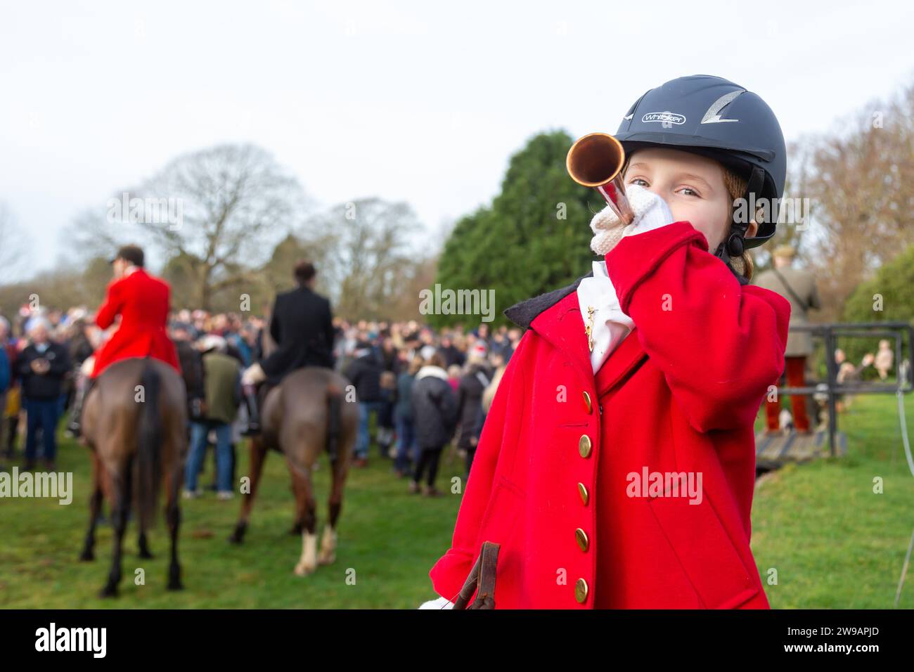 Hagley, Worcestershire, UK. 26th Dec, 2023. 4 year old Myla Mills blows her horn for the hunt riders and hounds at the Albrighton and Woodland Hunt's Boxing Day meet at Hagley Hall, Worcestershire. Credit: Peter Lopeman/Alamy Live News Stock Photo