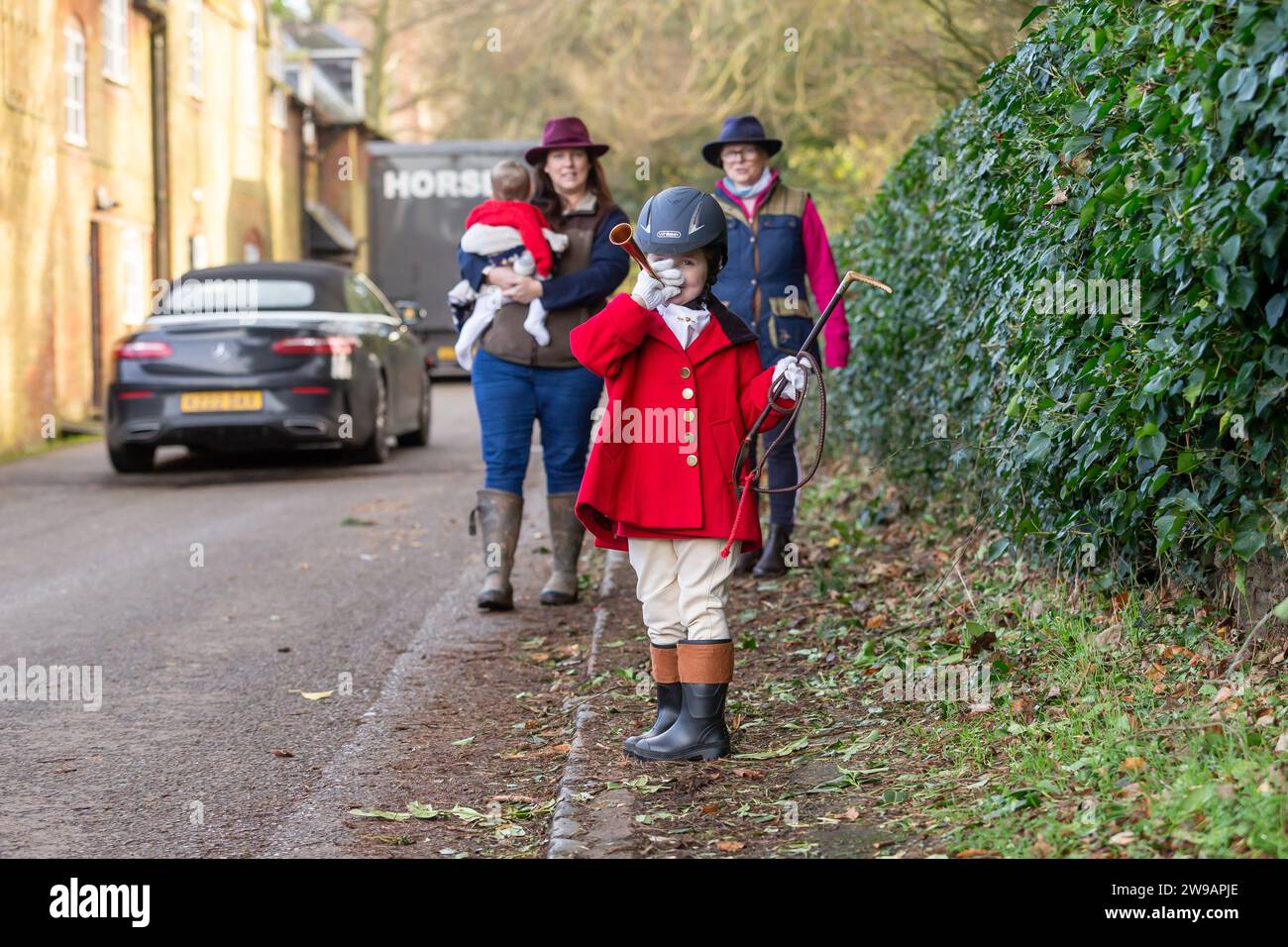 Hagley, Worcestershire, UK. 26th Dec, 2023. 4 year old Myla Mills welcomes the hunt riders and hounds at Albrighton and Woodland Hunt's Boxing Day meet at Hagley Hall, Worcestershire. Credit: Peter Lopeman/Alamy Live News Stock Photo