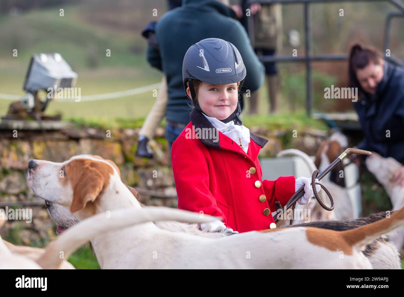 Hagley, Worcestershire, UK. 26th Dec, 2023. 4 year old Myla Mills stands among the hunt riders and hounds at Albrighton and Woodland Hunt's Boxing Day meet at Hagley Hall, Worcestershire. Credit: Peter Lopeman/Alamy Live News Stock Photo