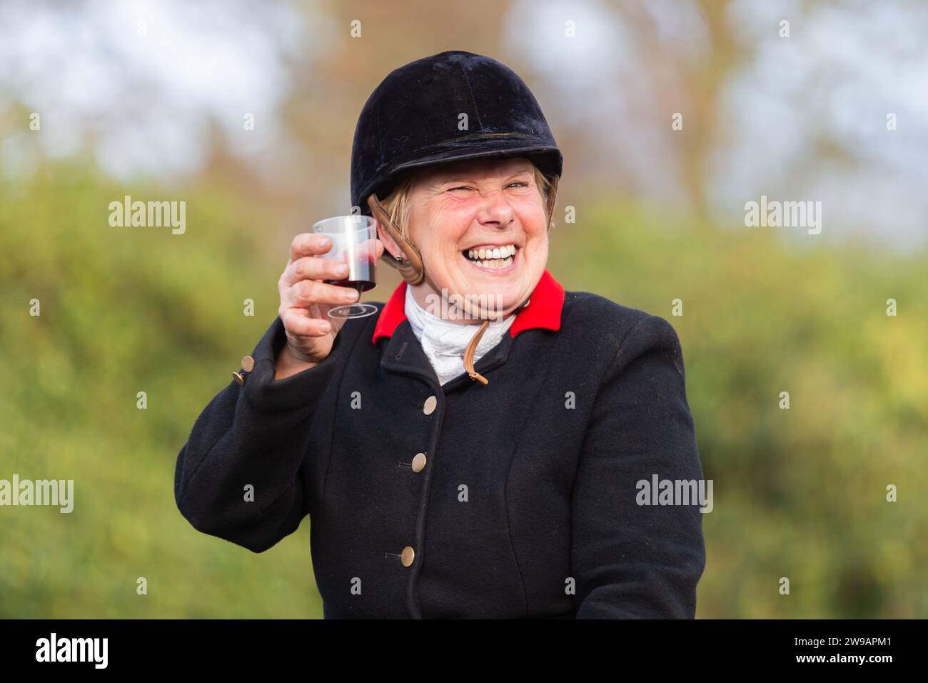Hagley, Worcestershire, UK. 26th Dec, 2023. A happy rider enjoys a glass of sherry at the Albrighton and Woodland Hunt's Boxing Day meet at Hagley Hall, Worcestershire. Credit: Peter Lopeman/Alamy Live News Stock Photo