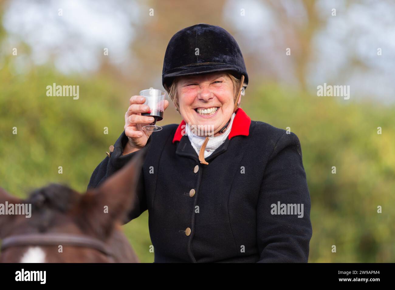 Hagley, Worcestershire, UK. 26th Dec, 2023. A happy rider enjoys a glass of sherry at the Albrighton and Woodland Hunt's Boxing Day meet at Hagley Hall, Worcestershire. Credit: Peter Lopeman/Alamy Live News Stock Photo