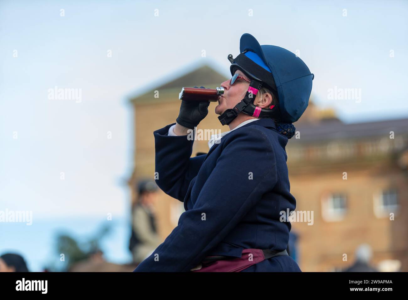 Hagley, Worcestershire, UK. 26th Dec, 2023. A happy rider enjoys a sip of something stronger at the Albrighton and Woodland Hunt's Boxing Day meet at Hagley Hall, Worcestershire. Credit: Peter Lopeman/Alamy Live News Stock Photo