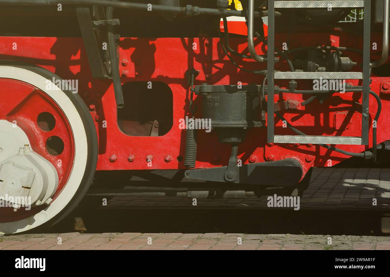 Wheels of the old black steam locomotive of Soviet times. The side of ...
