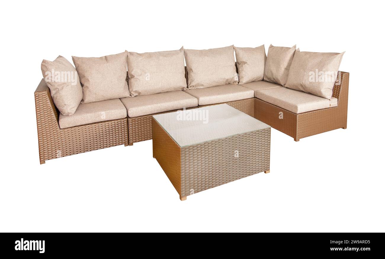 Wicker rattan furniture for the garden or terrace. Comfortable sofa with soft pillows and a coffee table. Stock Photo