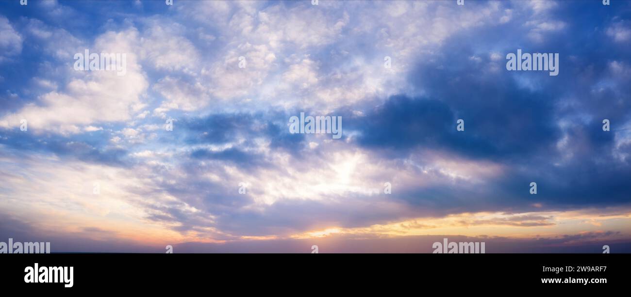 Beautiful sunset sky with clouds and bright sunlight. Background. Stock Photo