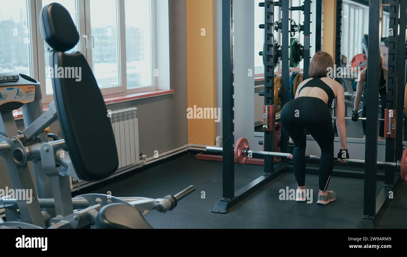 Two young women working out in gym, using gym equipment, Stock
