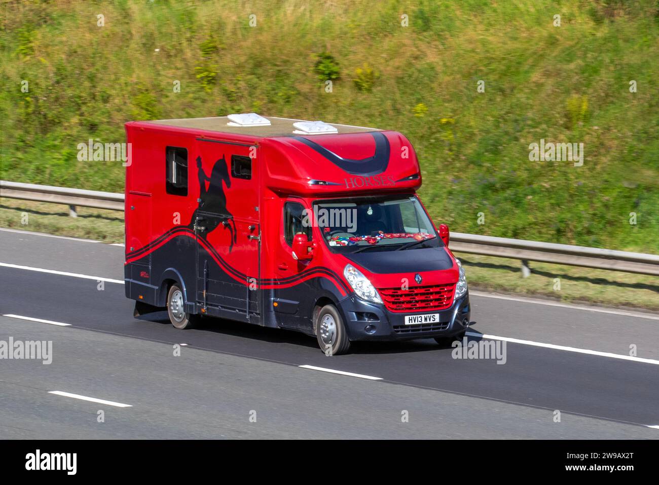 2013 Red Renault Master Lm35 Dci 125 L3H2 LWB Medium Roof Panel Van Diesel 2299 cc, 125hp 2.3-litre 4-cylinder diesel  horsebox; travelling at speed on the M6 motorway in Greater Manchester, UK Stock Photo
