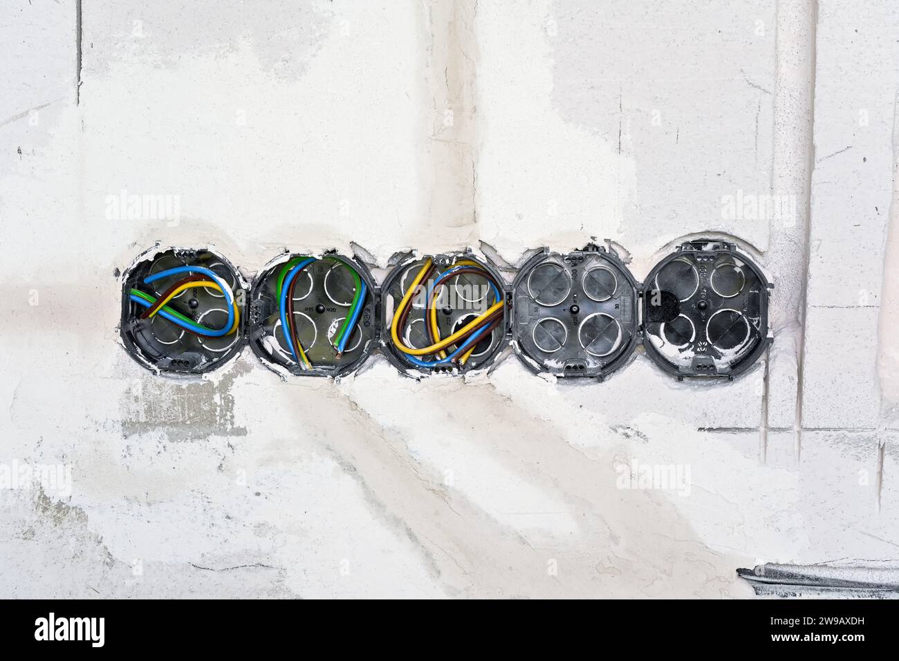 Boxes with cables for electric sockets installed in new house building