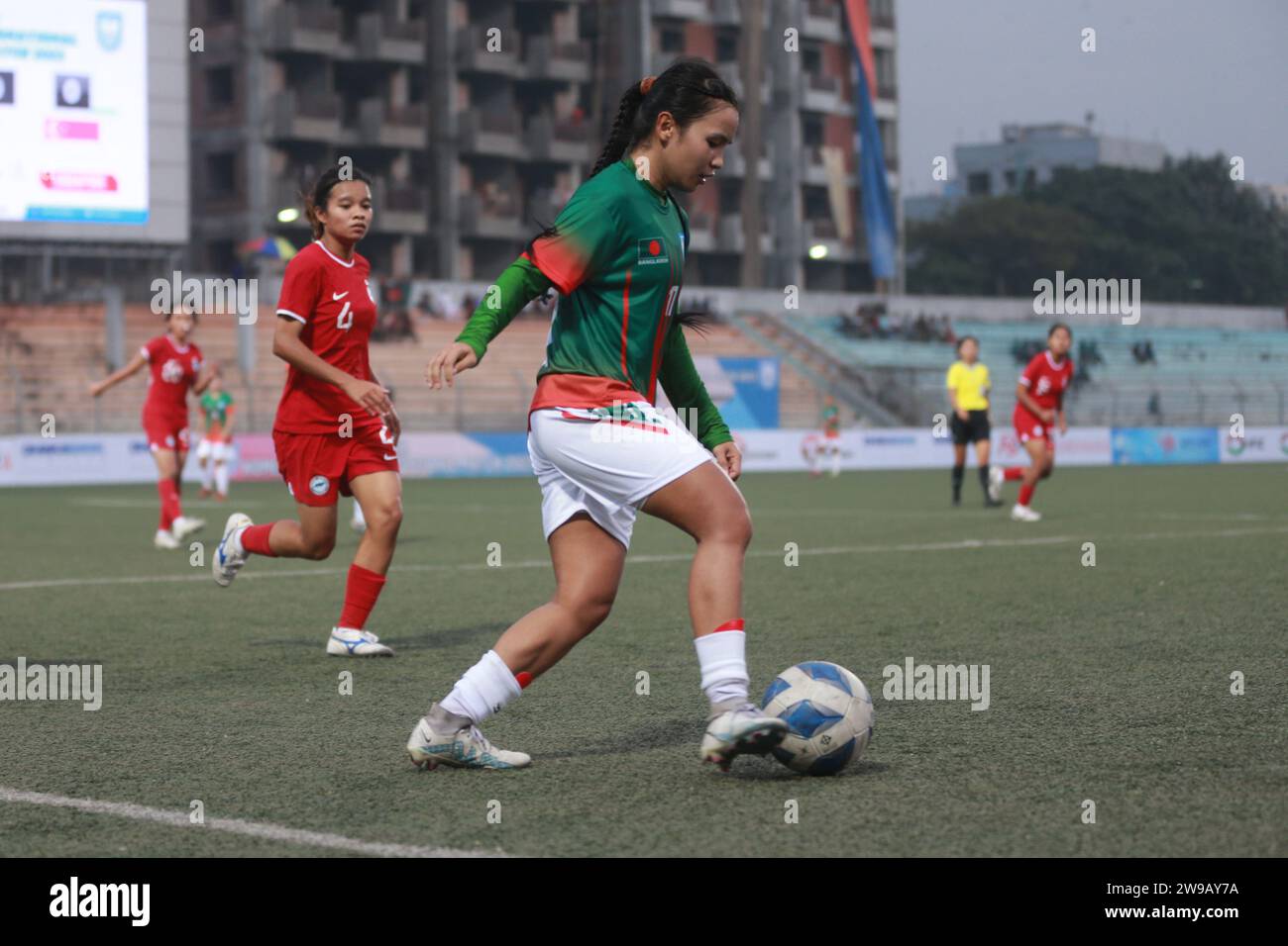 Bangladeshi midfilder Ritu Porna Chakma (Green) try to takes control as Bangladesh national women's team capped off their FIFA friendly window with a Stock Photo