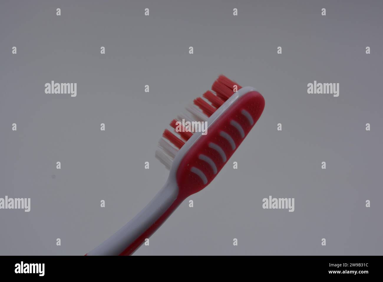 Personal hygiene products, a new plastic toothbrush with red and white ...