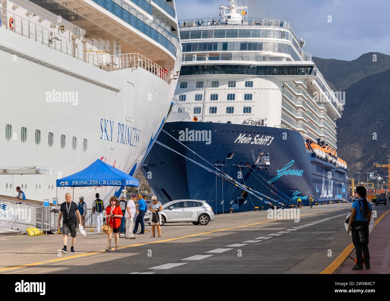 Mein Schiff 3 cruise ship owned by TUI docked next to Sky Princess cruise ship, owned by Carnival Corporation at Muelle Sur cruise terminal, Tenerife Stock Photo