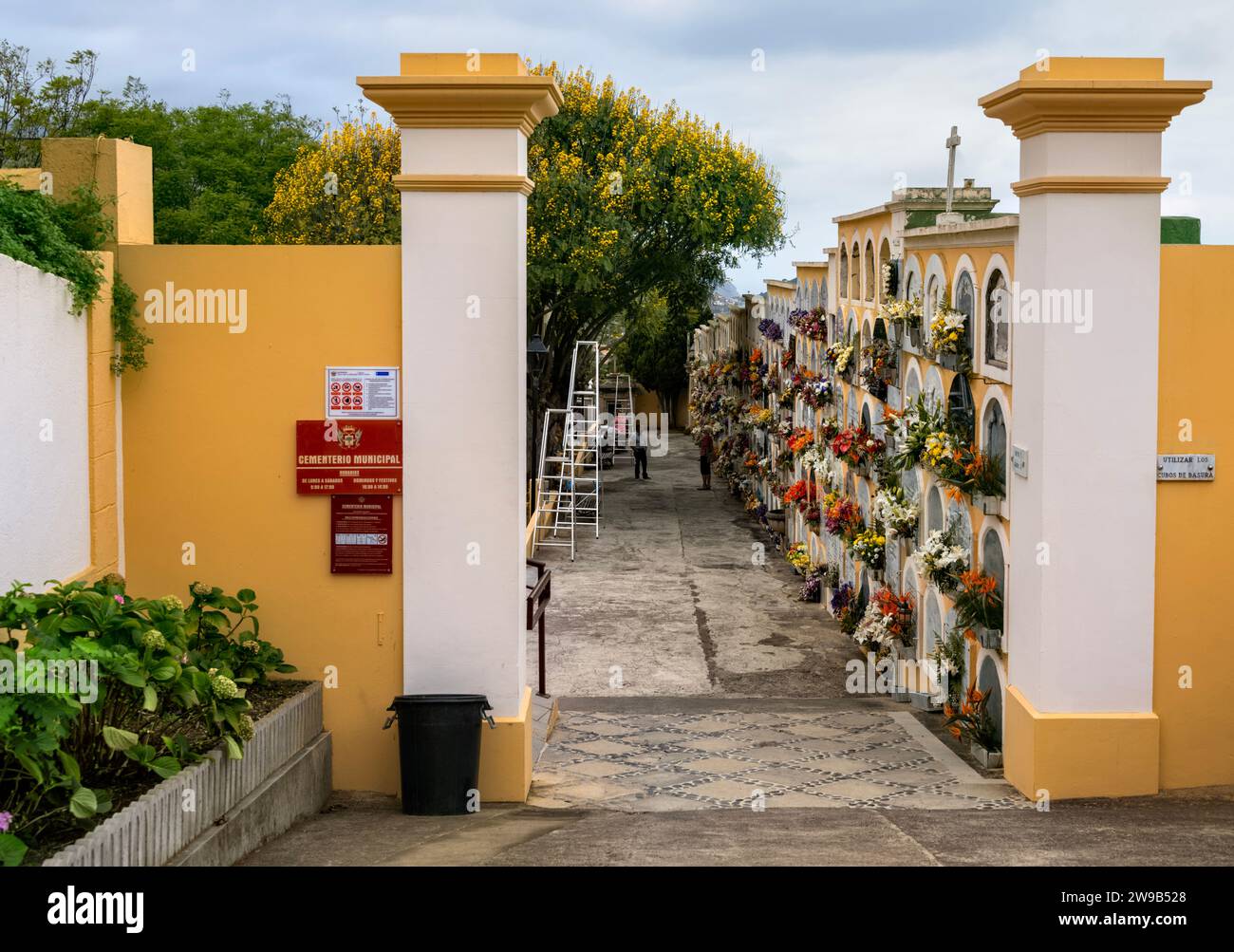 Entrance to Municpal Cemetery, La Orotava, Tenerife showing close up of marble gravestones/memorials to the deceased adorned with fresh flowers. Stock Photo