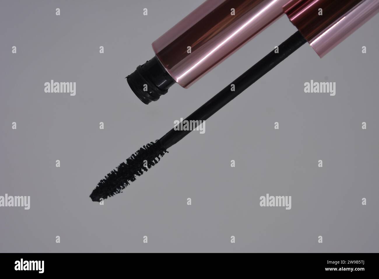 Women's cosmetics, beautiful pink metal eye brush, black stylish mascara set on white background. Stock Photo