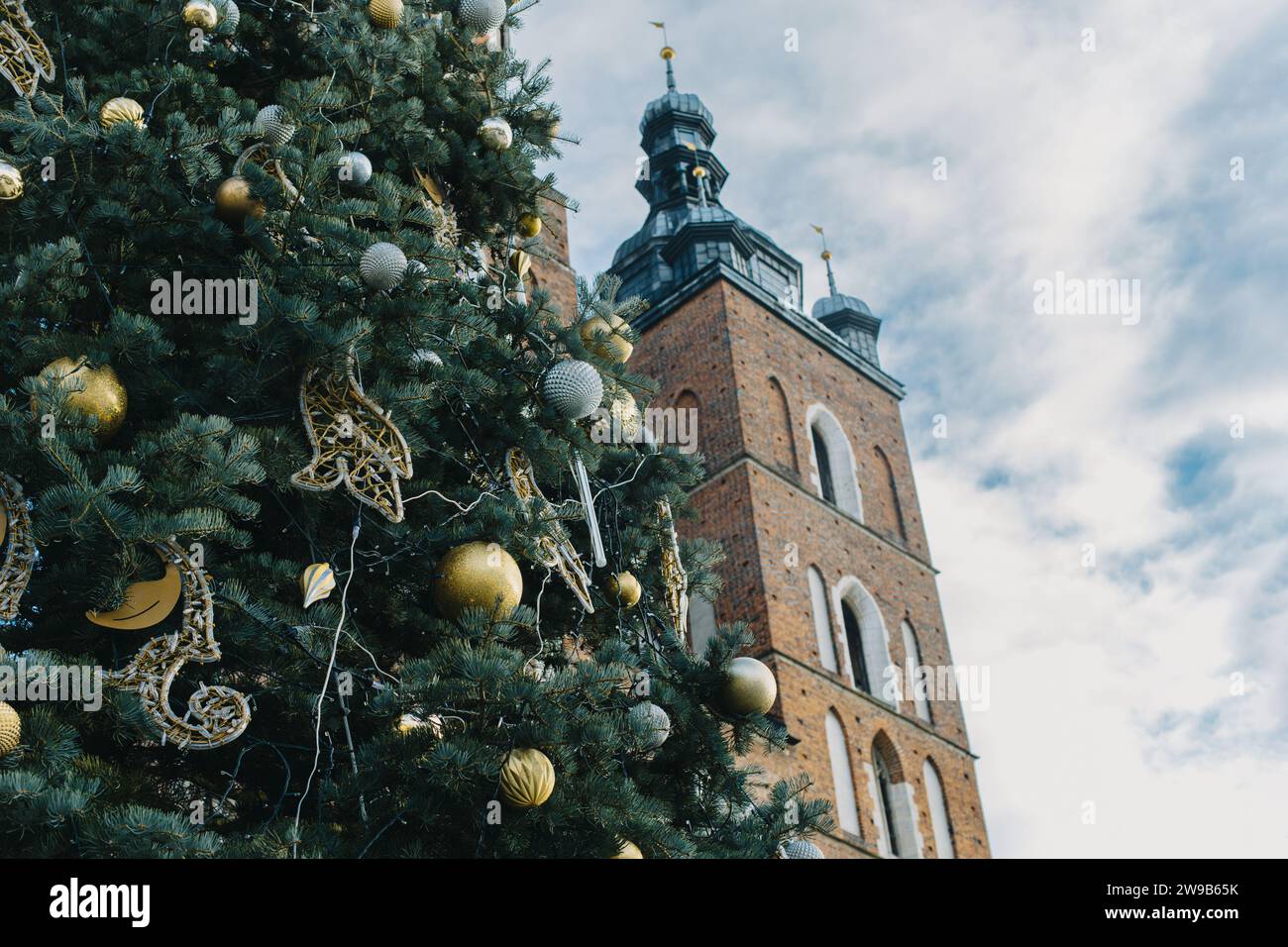 Amazing view of Krakov old town and Christmas tree in a sunny winter day. Travel destination in Poland. Stock Photo