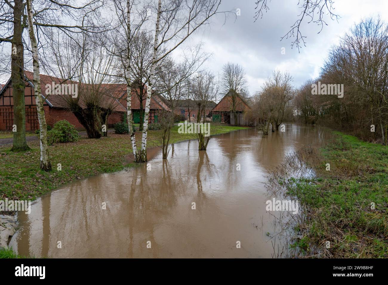 Flooded area next to a historic farm near Petershagen-Ilserheide on 2nd Christmas day 2023 Stock Photo