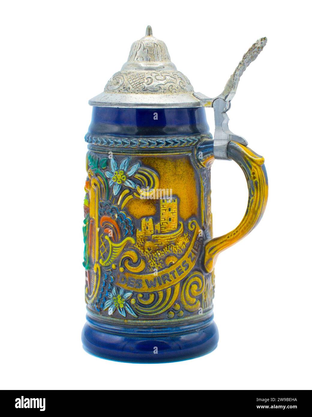 Old Vintage German beer stein Mug with pewter hinged top with words ein gutes bier des wirtes zier good beer from the landlord and men drinking at a t Stock Photo